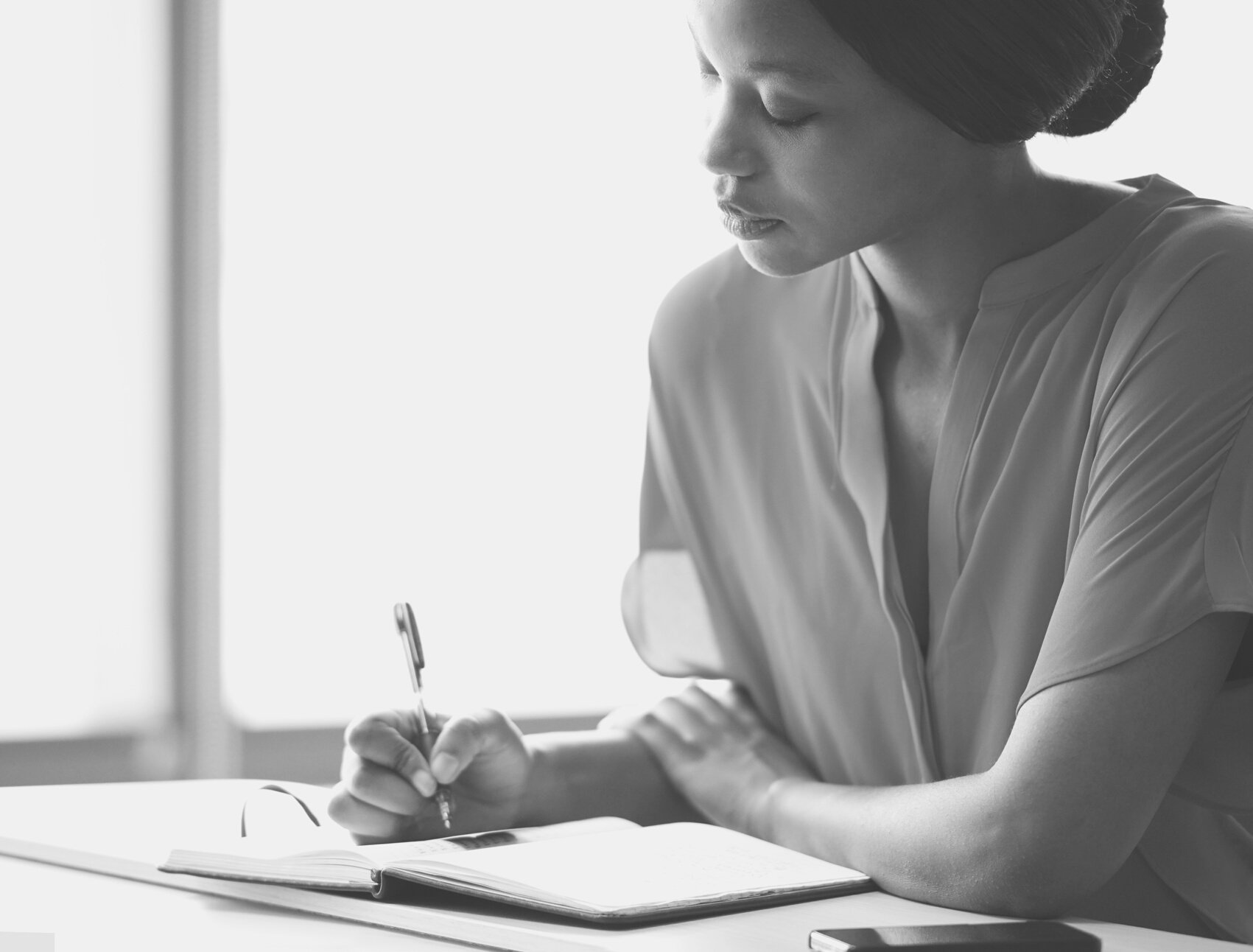 Tight image of elegant young black writer busy hand writing